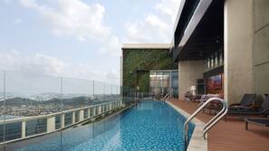 Outdoor pool, open 7 AM to 7 PM, pool umbrellas