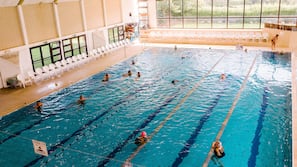 Una piscina cubierta, una piscina al aire libre de temporada, tumbonas