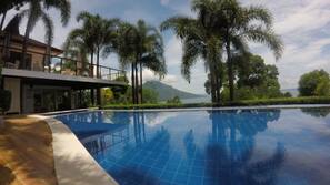 Outdoor pool, open 6 AM to 10 PM, pool umbrellas, sun loungers