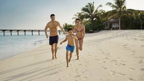 On the beach, white sand, beach umbrellas, beach towels