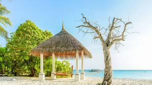 On the beach, white sand, sun-loungers, beach towels