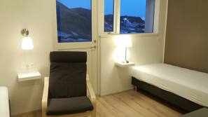 Premium bedding, desk, laptop workspace, blackout drapes