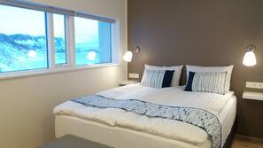 Premium bedding, desk, laptop workspace, blackout drapes