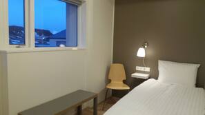 Premium bedding, desk, laptop workspace, blackout drapes