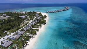 On the beach, white sand, sun-loungers, beach umbrellas