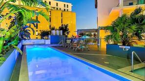 Outdoor pool, open 7 AM to 10 PM, pool loungers