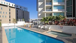 Outdoor pool, open 7 AM to 10 PM, pool loungers