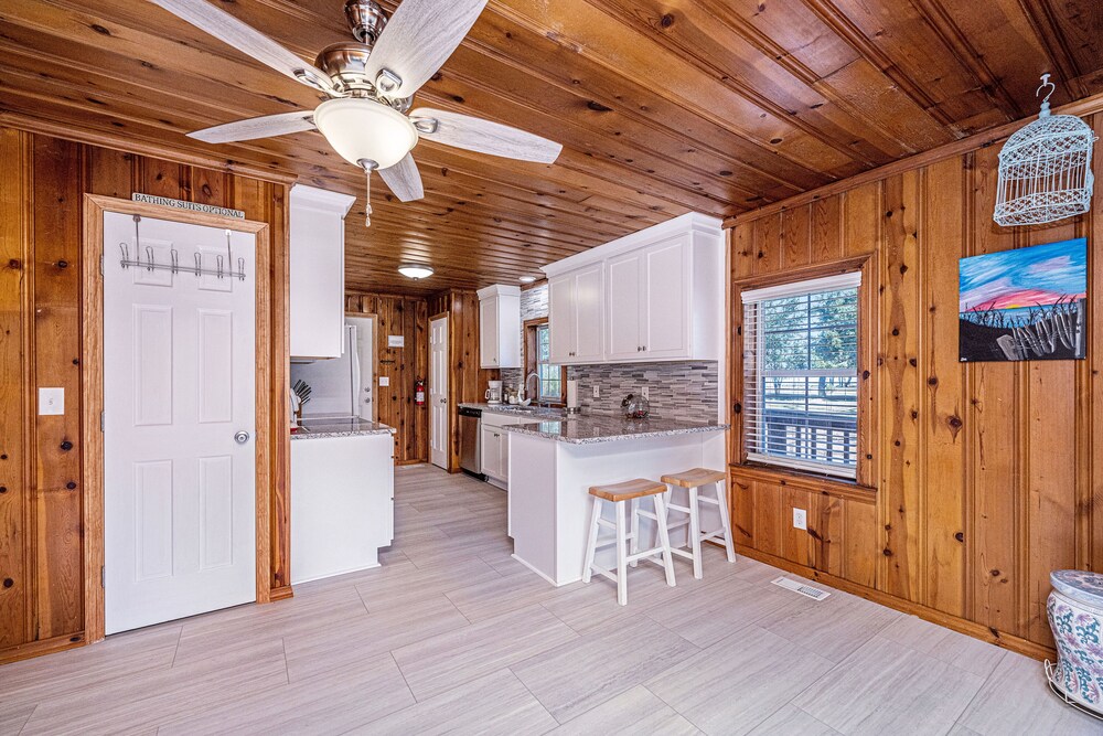 Completely renovated lake house with boat landing, dock, fire pit and