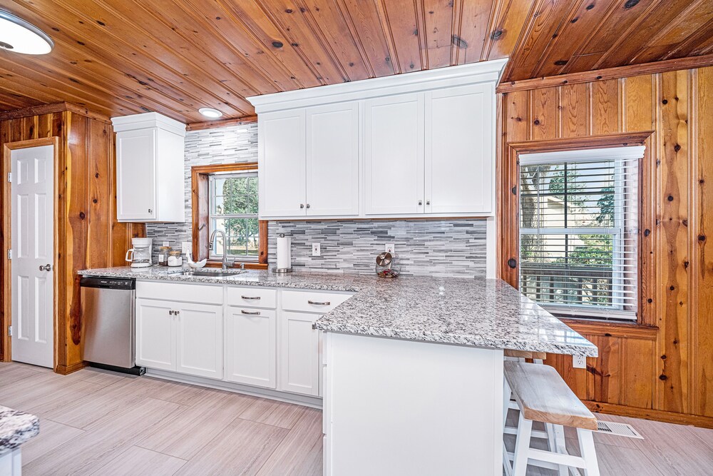 Completely renovated lake house with boat landing, dock, fire pit and