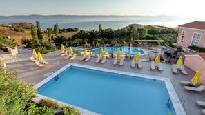 2 outdoor pools, a waterfall pool, open 8 AM to 8 PM, pool umbrellas