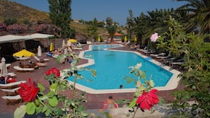 2 outdoor pools, a waterfall pool, open 8 AM to 8 PM, pool umbrellas