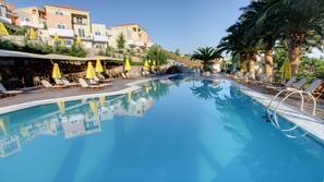 2 outdoor pools, a waterfall pool, open 8 AM to 8 PM, pool umbrellas