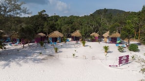 On the beach, white sand, sun-loungers, beach towels