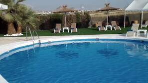 Seasonal outdoor pool, open 11:00 AM to 9 PM, pool umbrellas