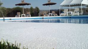 Seasonal outdoor pool, open 11:00 AM to 9 PM, pool umbrellas