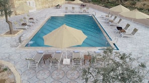 Indoor pool, seasonal outdoor pool, open 6 AM to 9:00 PM, pool umbrellas