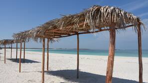 On the beach, sun-loungers