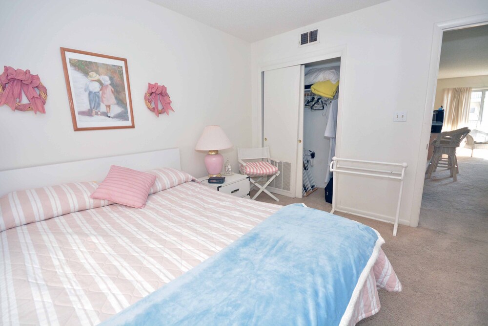 Comfortable, spacious 2-bedroom condo with free WiFi and adorable spring decor located midtown and just a block from the beach!