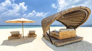 On the beach, white sand, sun-loungers, beach umbrellas