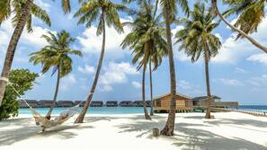On the beach, white sand, sun-loungers, beach umbrellas