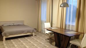 Premium bedding, desk, laptop workspace, iron/ironing board