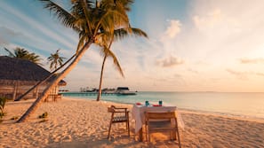 On the beach, white sand, sun-loungers, beach umbrellas