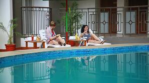 Indoor pool, open 7 AM to 7 PM, pool umbrellas