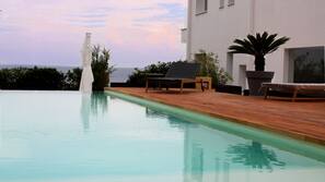 Outdoor pool, open 9:00 AM to 6:30 PM, pool umbrellas, pool loungers