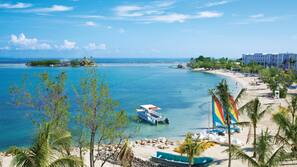 On the beach, white sand, sun loungers, beach towels