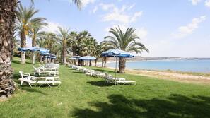 On the beach, sun-loungers, beach umbrellas, beach towels