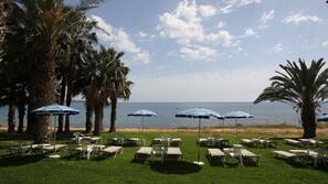 On the beach, sun-loungers, beach umbrellas, beach towels