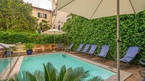 Seasonal outdoor pool, pool loungers