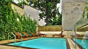 Seasonal outdoor pool, pool loungers