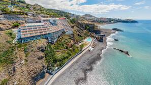On the beach, black sand, beach towels