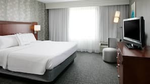 Premium bedding, desk, laptop workspace, blackout drapes