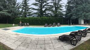 Seasonal outdoor pool, open 8:00 AM to 7:00 PM, pool umbrellas