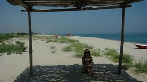 Sulla spiaggia, sabbia bianca, lettini da mare, ombrelloni