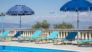 Seasonal outdoor pool, open 8 AM to 7 PM, pool umbrellas, pool loungers