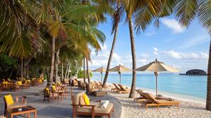 On the beach, white sand, beach towels, beach massages