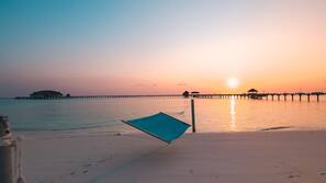 On the beach, white sand, beach towels, beach massages
