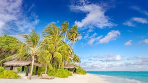 On the beach, white sand, beach towels, beach massages