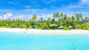 On the beach, white sand, beach towels, beach massages