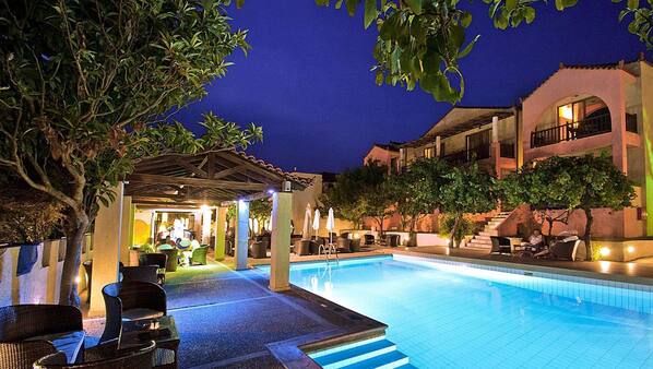 Seasonal outdoor pool, open 10:00 AM to 7:00 PM, pool umbrellas