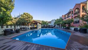 Seasonal outdoor pool, open 10:00 AM to 7:00 PM, pool umbrellas