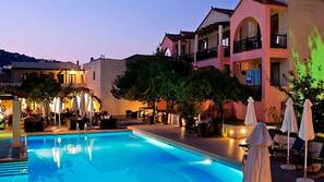 Seasonal outdoor pool, open 10:00 AM to 7:00 PM, pool umbrellas