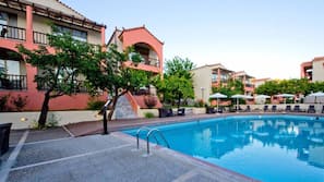 Seasonal outdoor pool, open 10:00 AM to 7:00 PM, pool umbrellas
