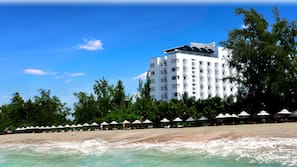On the beach, white sand, sun loungers, beach umbrellas