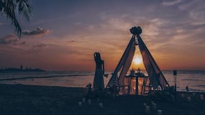 Di pantai, kursi berjemur, handuk pantai, dan pijat di pantai