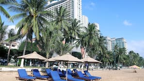 On the beach, white sand, sun-loungers, beach umbrellas