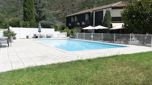 Seasonal outdoor pool, open 7:30 PM to 9 PM, pool umbrellas